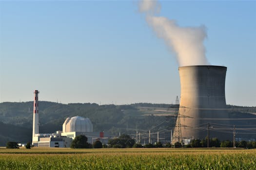 Power plant cooling tower releasing steam near Leibstadt, highlighting industrial energy production.